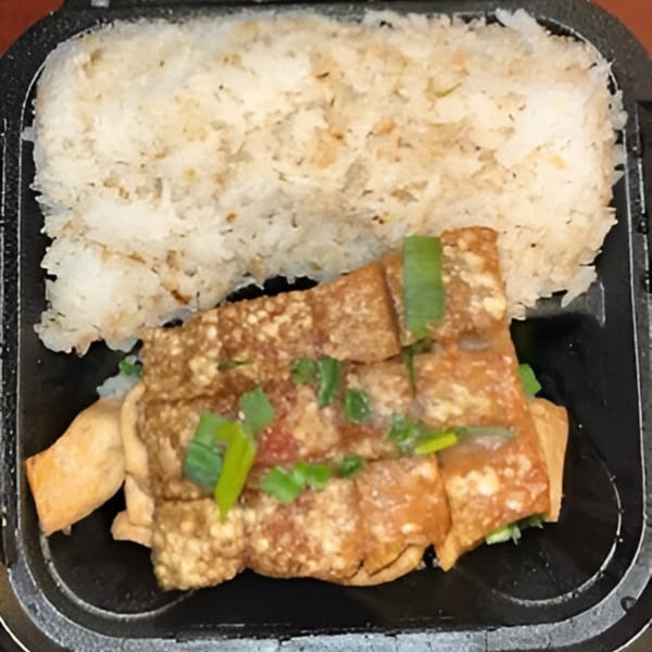 Chinese Kitchen's fried tofu with green onions and rice in a black takeout container.